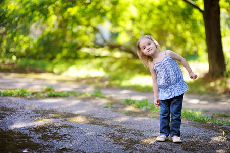 Adorable little girl smiling outdoorsの写真素材