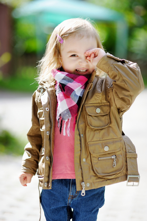 Adorable girl portrait outdoors at autumn or springの写真素材