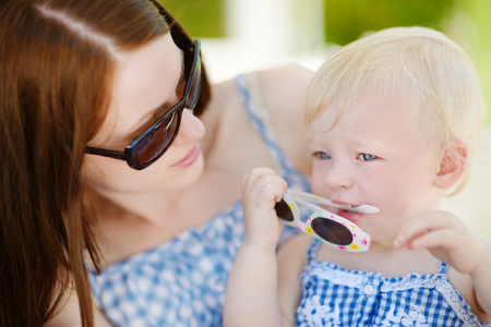 Mother and toddler daughter relaxing in outdoor restaurantの写真素材