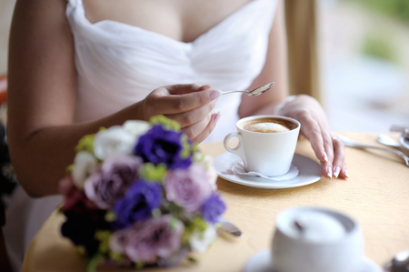 Beautiful bride enjoying a cup of coffeeの写真素材