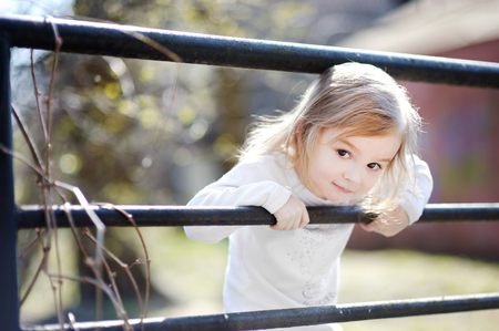 Adorable happy toddler girl smiling outdoorsの写真素材