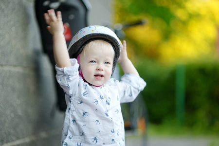 Little toddler girl ready to ride a bicycleの写真素材