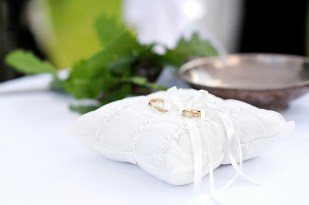 Two wedding ring on a white pillowの写真素材