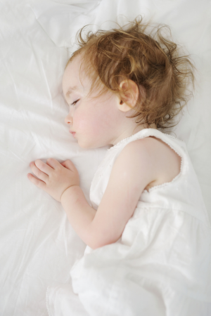 Adorable toddler girl sleeping like an angelの写真素材