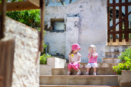Portrait of two cute little sisters outdoorsの写真素材