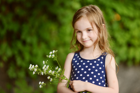 Adorable six years old girl on beautiful sunny day at summerの写真素材