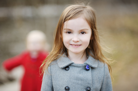 Adorable little girl picking the first flowers of springの写真素材