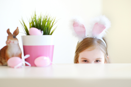 Adorable little girl wearing bunny ears on Easter day