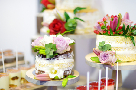 White wedding cake decorated with natural flowersの写真素材
