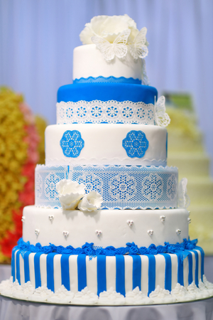 Big wedding cake decorated with blue flowersの写真素材