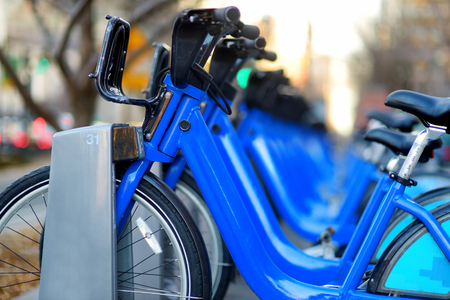 Row of city bikes for rent at docking stations in New York, USAの写真素材