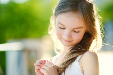 Adorable little girl on warm and sunny summer dayの写真素材