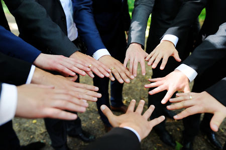 Groomsmen showing their hands at wedding