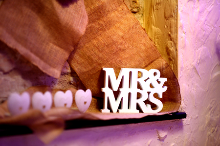 Fancy MR&MRS sign as a decoration on a table set for wedding receptionの写真素材