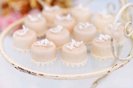 Decorated colorful cupcakes on a glass plateの写真素材