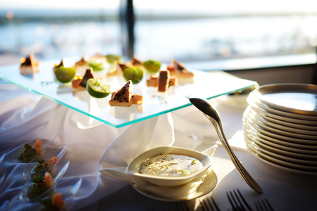 Plates with assorted finger food snacks on an event party or dinnerの写真素材
