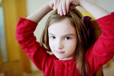 Portrait of a cute little happy girl at homeの写真素材