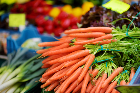 Bunches of organic carrots sold on farmer's marketの写真素材
