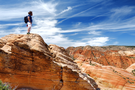 Hiker admiring views of stunning colorful sandstone formations of Yant Flat, Utah, USAの写真素材