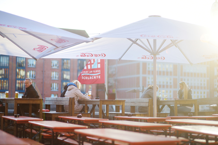 BREMEN, GERMANY - MARCH 23, 2016: Tourist having a beer in a restaurant on an embarktment of Weser river in Bremenのeditorial素材