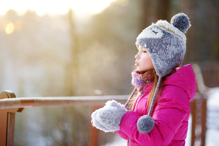 Funny little girl having fun in beautiful winter parkの写真素材