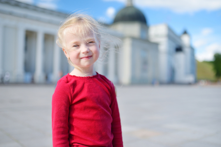 Two cute little girl sightseeing on the streets of Vilnius, Lithuania on warm and sunny summer dayの写真素材