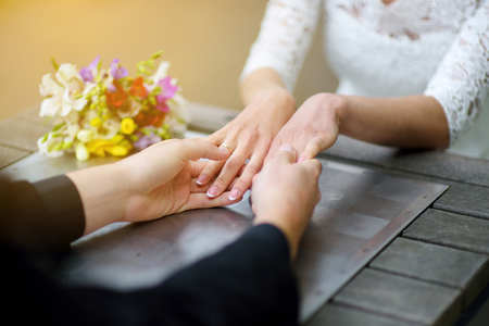 Bride and groom holding their hands on a wedding dayの写真素材