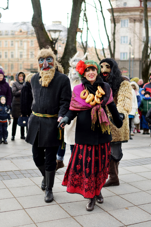VILNIUS, LITHUANIA - FEBRUARY 25, 2017: Hundreds of people celebrating Uzgavenes, a Lithuanian annual folk festival taking place before Easter. Participants wearing traditional masks and costumes.のeditorial素材