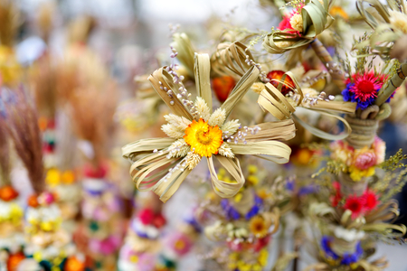 Traditional Lithuanian Easter palms known as verbos sold on Easter market in Vilnius. Lithuanian capital's annual traditional crafts fair is held every March on Old Town streets.の写真素材