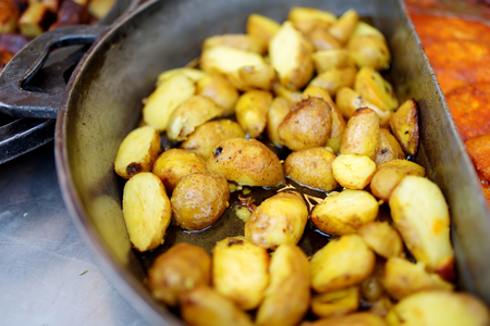 Traditional fried potatos being cooked at the spring market in Vilnius, Lithuania. Variety tasty street food on Easter fair.の写真素材