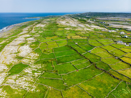 Aerial view of Inishmore or Inis Mor, the largest of the Aran Islands in Galway Bay, Ireland. Famous for its strong Irish culture, loyalty to the Irish language, and a wealth of ancient sites.の写真素材
