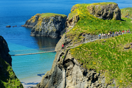 Carrick-a-Rede Rope Bridge, famous rope bridge near Ballintoy in County Antrim, linking the mainland to the tiny island of Carrickarede. One of the most iconic tourist attractions in Nothern Ireland.の写真素材