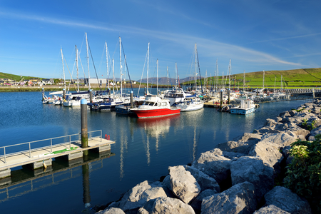 Colorful fishing boats and yachts at the harbor of Dingle town on the West Atlantic coast of Ireland. Small towns and villages on famous Dingle Peninsula tourist route.の写真素材