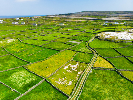 Aerial view of Inishmore or Inis Mor, the largest of the Aran Islands in Galway Bay, Ireland. Famous for its strong Irish culture, loyalty to the Irish language, and a wealth of ancient sites.の写真素材