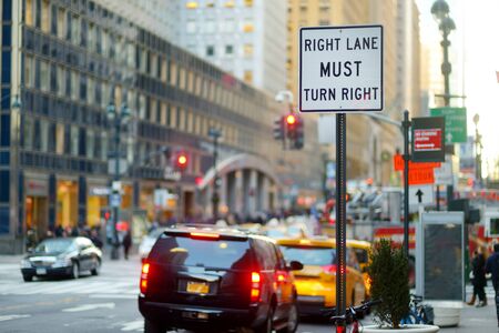 Roadsign in New York. Cars, taxi cabs and people rushing on busy streets of downtown Manhattan. Iconic NYC street views.の写真素材
