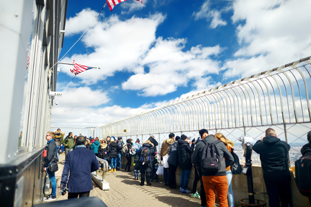 NEW YORK - MARCH 16, 2015: Tourists enjoying breathtaking views from the main observation deck of Empire State Building.のeditorial素材
