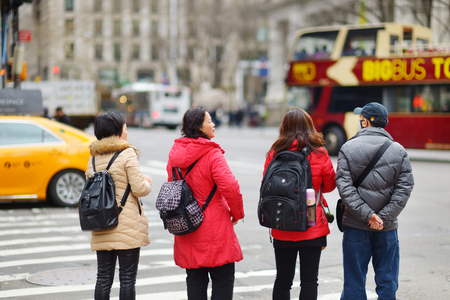 NEW YORK - MARCH 16, 2015: People crossing a street in downtown Manhattan. Tourists and newyorkers walking across a busy NYC crosswalk.のeditorial素材