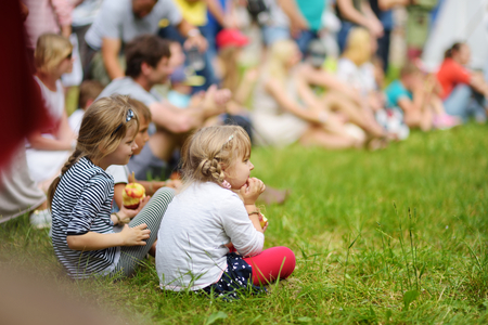 TRAKAI, LITHUANIA - JUNE 16, 2018: Kids and adults enjoying historical reenactment on annual Medieval Festival, held in Trakai Peninsular Castle. Visitors watching the jousting show.のeditorial素材