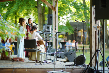 TRAKAI, LITHUANIA - JUNE 16, 2018: Historical reenactment activists playing folk-rock music during annual Medieval Festival, held in Trakai Peninsular Castle. Recreating medieval town spirit.のeditorial素材