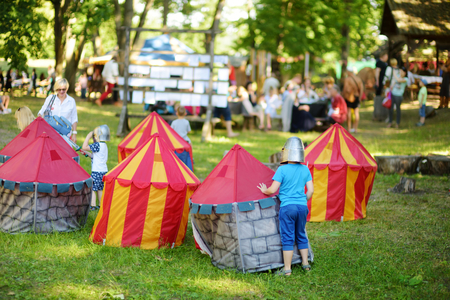 TRAKAI, LITHUANIA - JUNE 16, 2018: Children having fun during annual Medieval Festival, held in Trakai Peninsular Castle. Recreating medieval town spirit.のeditorial素材