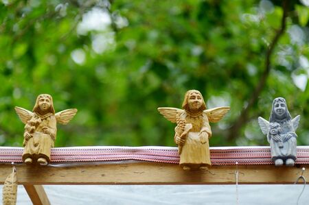Cute colorful wooden angels sold on summer fair in Vilnius.の写真素材