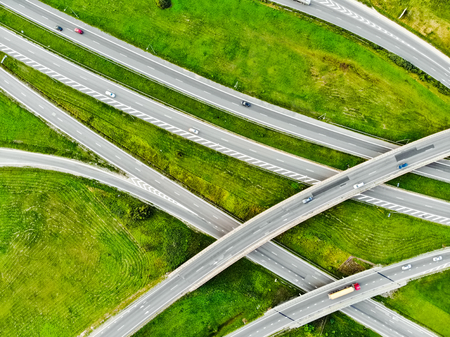 Aerial top down view of a highway road intersection. Cars passing, highway junction, cross roads. Kaunas, Lithuania.の写真素材