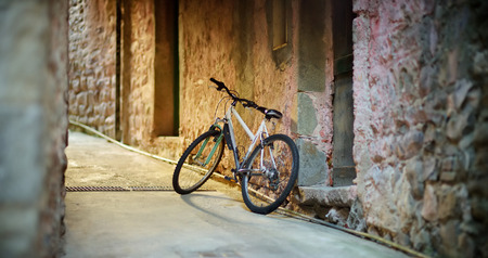 Old bicycle parked on the street of Corniglia, nestled in the middle of the five centuries-old villages of Cinque Terre, located on rugged northwest coast of Italian Riviera, Liguria, Italy.の写真素材