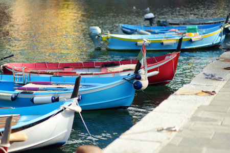 Colourful fishing boats in small marina of Vernazza, one of the five centuries-old villages of Cinque Terre, located on rugged northwest coast of Italian Riviera, Liguria, Italy.の写真素材