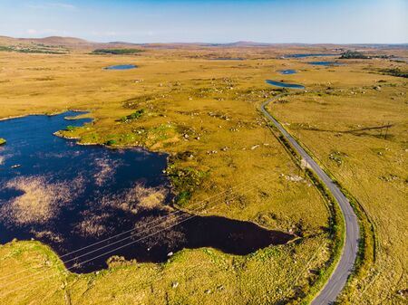 Beautiful aerial sunset view of Connemara region in Ireland. Scenic Irish countryside landscape with...