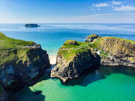 Carrick-a-Rede Rope Bridge, famous rope bridge near Ballintoy in County Antrim, linking the mainland to the tiny island of Carrickarede. One of the most iconic tourist attractions in Nothern Ireland.の写真素材
