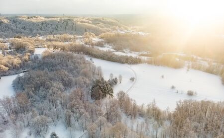 Beautiful aerial view of snow covered pine forests. Rime ice and hoar frost covering trees. Scenic winter landscape near Vilnius, Lithuania.の写真素材