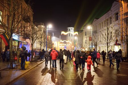 VILNIUS, LITHUANIA - FEBRUARY 16, 2018: Hundreds of people attending the celebration of Restoration of the State Day in Vilnius. Bonfires are lit on Gediminas avenue on festive night on February 16.のeditorial素材