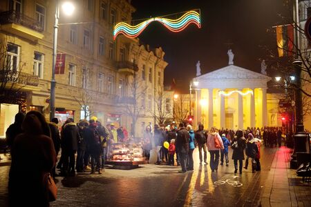 VILNIUS, LITHUANIA - FEBRUARY 16, 2018: Hundreds of people attending the celebration of Restoration of the State Day in Vilnius. Bonfires are lit on Gediminas avenue on festive night on February 16.のeditorial素材