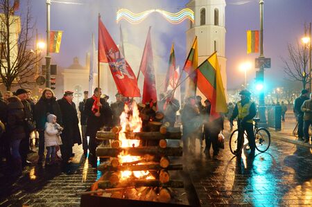 VILNIUS, LITHUANIA - FEBRUARY 16, 2018: Hundreds of people attending the celebration of Restoration of the State Day in Vilnius. Bonfires are lit on Gediminas avenue on festive night on February 16.のeditorial素材